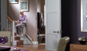 elderly woman using a stairlift