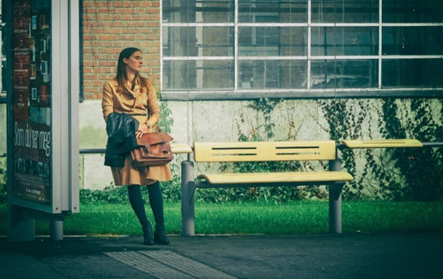 Woman resting on a perch seat