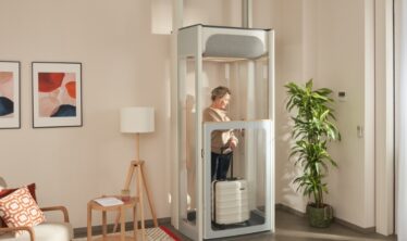 Middle age woman on her Stannah Uplifts S2 homelift.