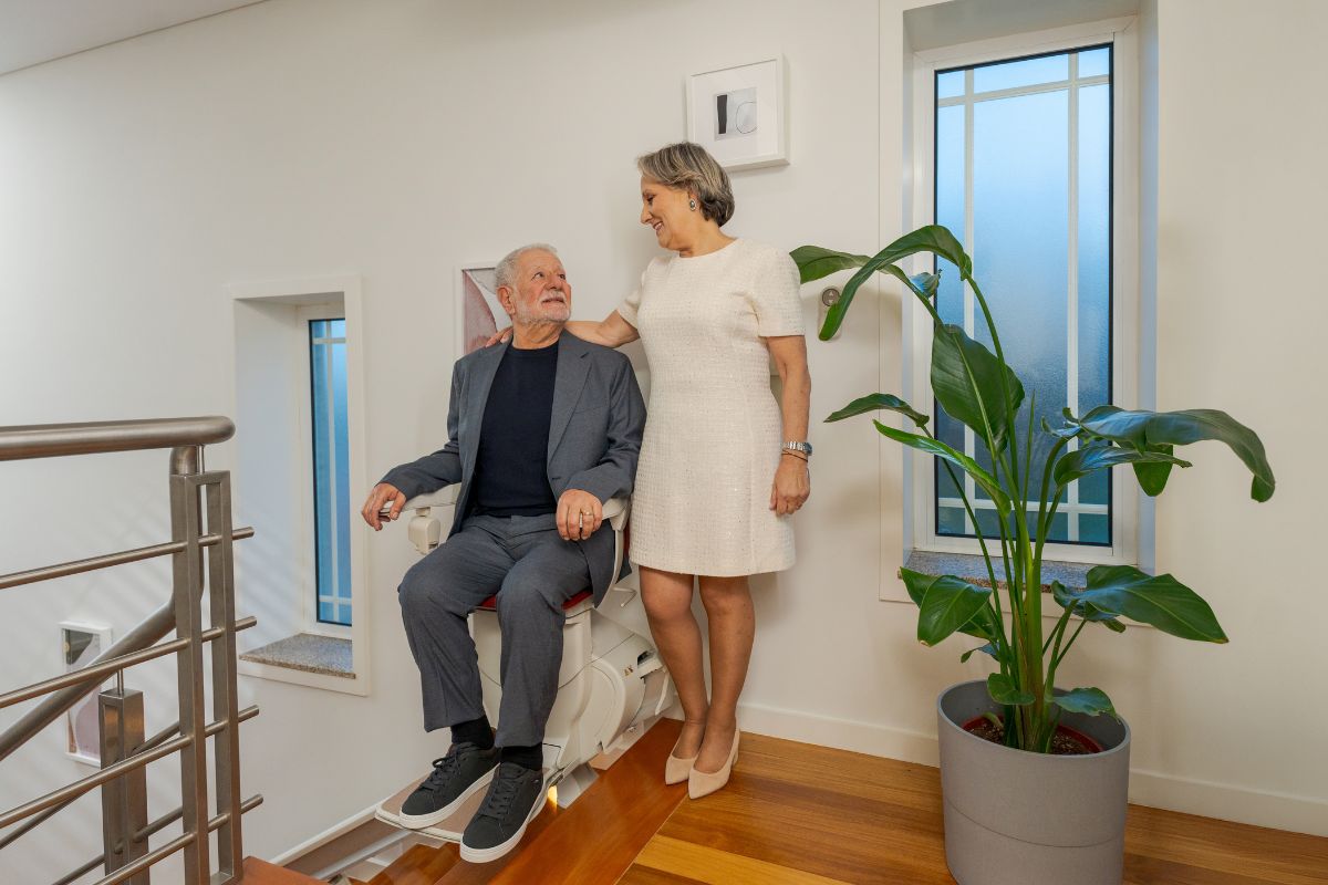 Happy couple at home, with a Stannah stairlift