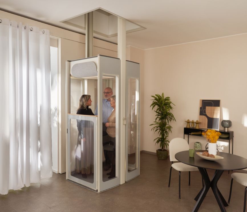Three people on a modern Uplifts S3 home lift.